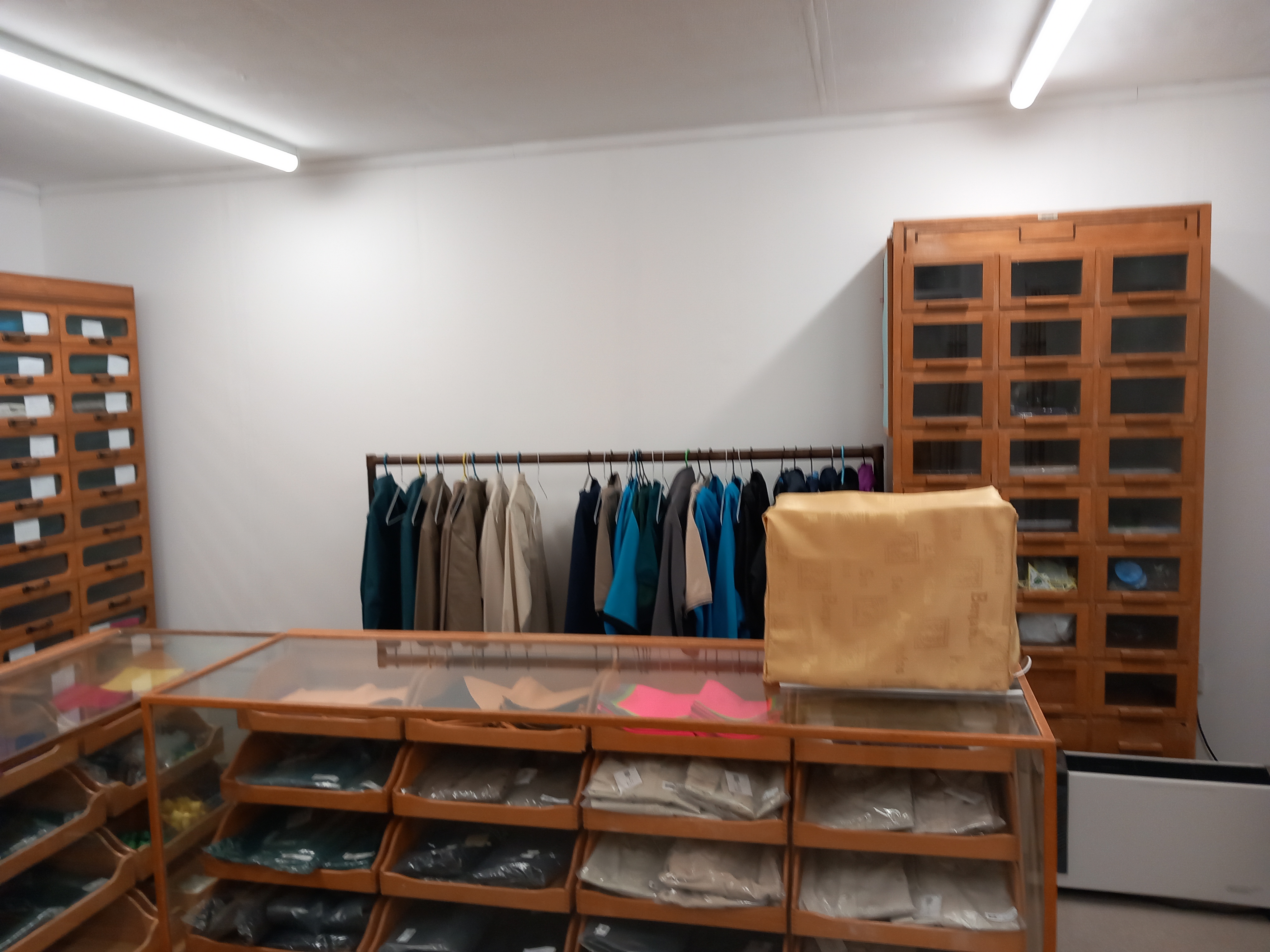 The main shop counter with folded Scout uniform and wooden storage drawers